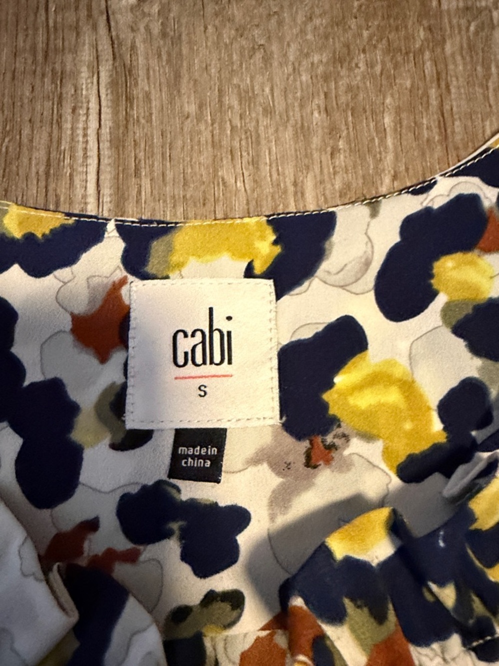 CAbi Fierce Seeing Spots sleeveless blouse featuring a colorful animal print - Picture 2 of 6